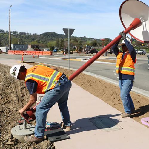WBE traffic workers installing street lighting