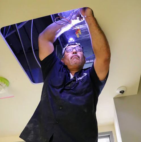 WBE security foreman working on installing security system